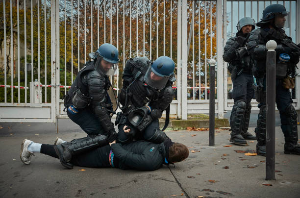 French Riot Police arrest a Gilet Jaune, or Yellow Vest protestor, as protests to mark the Anniversary of the Gilets Jaune movement turn violent in...