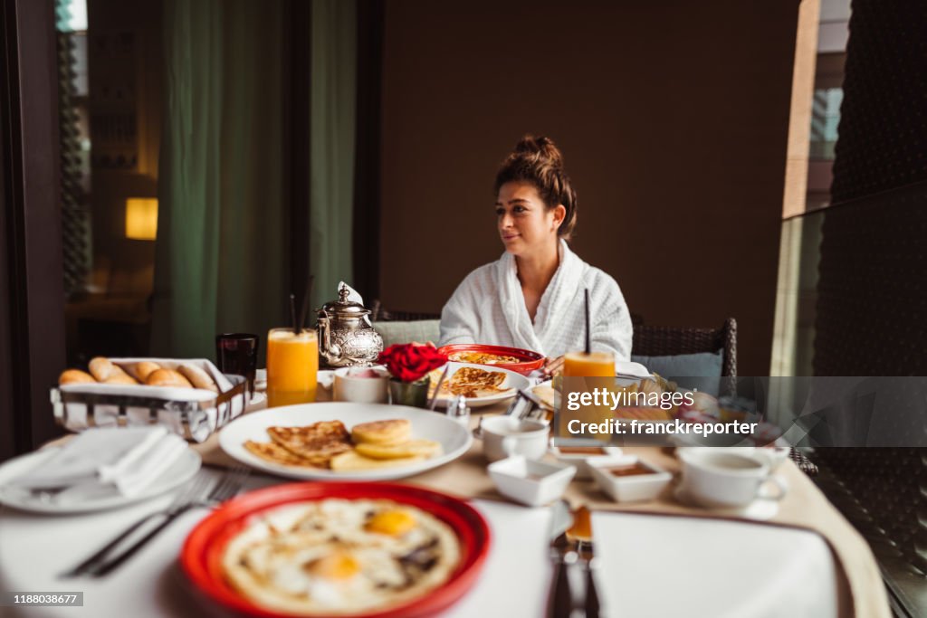 Woman at the table for the buffet breakfast with fruit