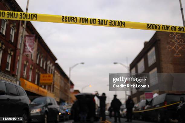 Detail of a police line band as recovery and clean up crews arrive to the JC Kosher Supermarket in the aftermath of a mass shooting on December 11,...