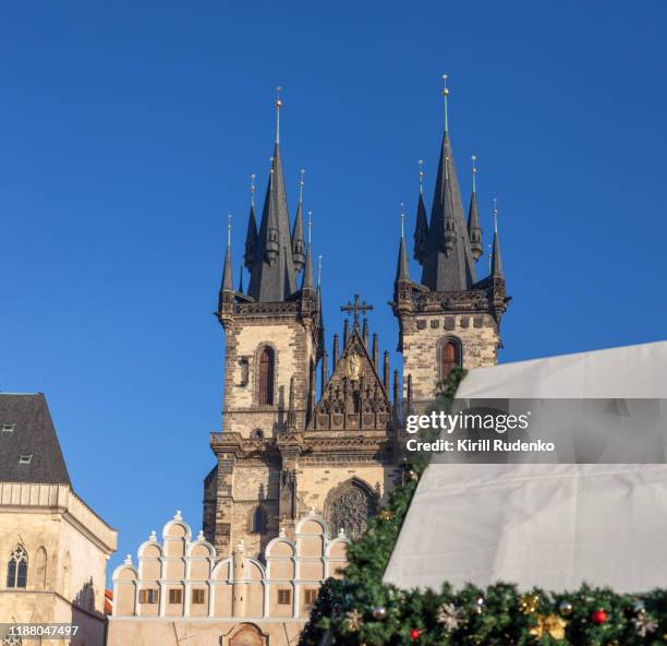 tyn church and christmas market stalls in old town on a sunny day, prague, czech republic - prague christmas market old town stock pictures, royalty-free photos & images