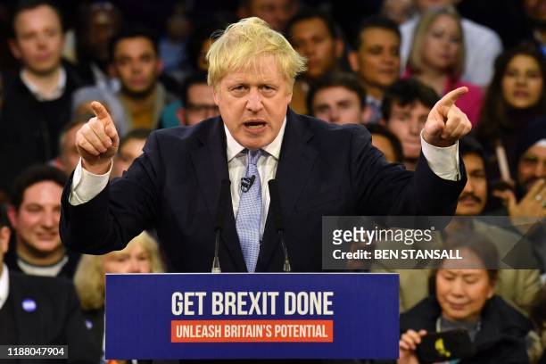 Britain's Prime Minister and Conservative party leader Boris Johnson speaks during a general election campaign rally in East London on December 11...