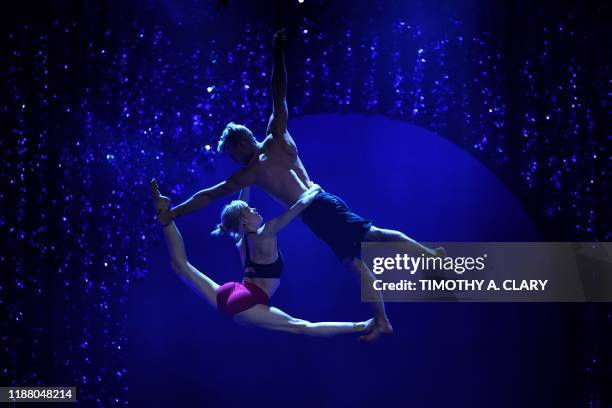 Cirque du Soleil's Nicole Faubert and Guillaume Paquin perform on the Aerial Duo Straps during a rehearsal for Twas the Night Before... At the Hulu...