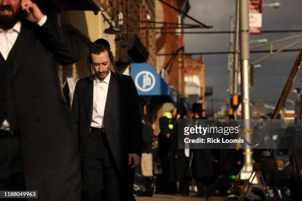Members of the Jewish community gather around the JC Kosher Supermarket on December 11, 2019 in Jersey City, New Jersey. Six people, including a...