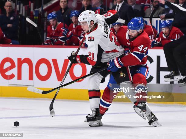 Nate Thompson of the Montreal Canadiens challenges Logan Brown of the Ottawa Senators during the first period at the Bell Centre on December 11, 2019...