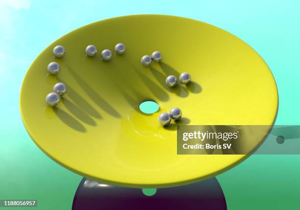 spinning balls in large funnel - 重力場 ストックフォトと画像