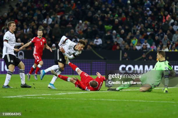 Pavel Nekhajchik of Belarus is tackled by Robin Koch of Germany inside the area which later leads to a penalty awarded to Belarus during the UEFA...