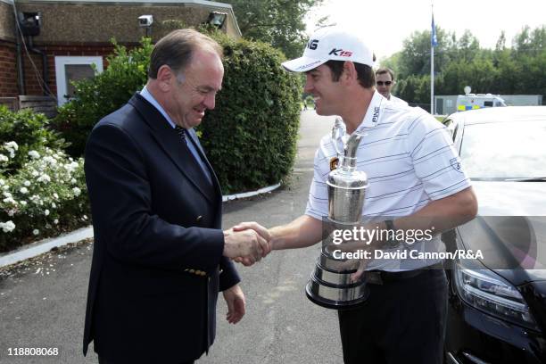 Open Champion Louis Oosthuizen of South Africa greets Peter Dawson, chief executive of The R&A during the first practice round during The Open...