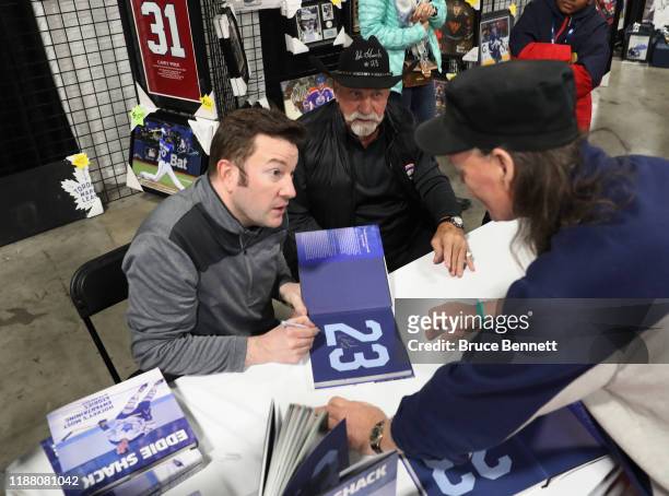 Ken Reid and Eddie Shack sign their book during the Sports Memorabilia Show on November 16, 2019 at the International Centre in Mississauga, Ontario,...