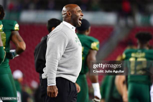 Head coach Charlie Strong of the South Florida Bulls calls to a player during warmup before a game against the Cincinnati Bearcats at Raymond James...