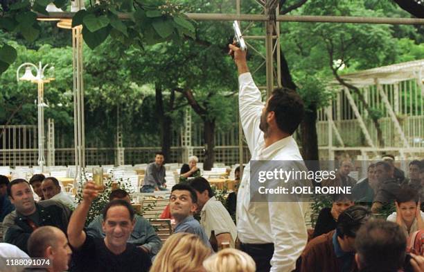 Supporter shoots in the air as celebrating the victory of Milo Djukanovic's party "To Live Better"' in the parliamentary elections in Podgorica 01...