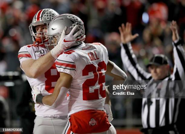 Jake Hausmann of the Ohio State Buckeyes celebrates his touchdown with teammate Jaelen Gill in the third quarter against the Rutgers Scarlet Knights...