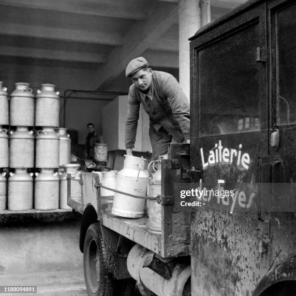 An employee works at the Fayes dairy in Isle on March 1946.