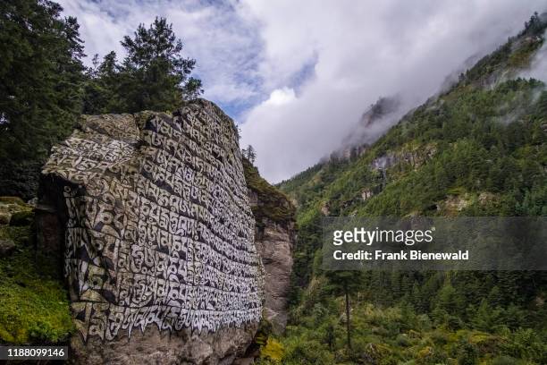 Big Mani Stone with the engraved tibetan mantra Om Mani Padme hum, located at the entrance of the village.