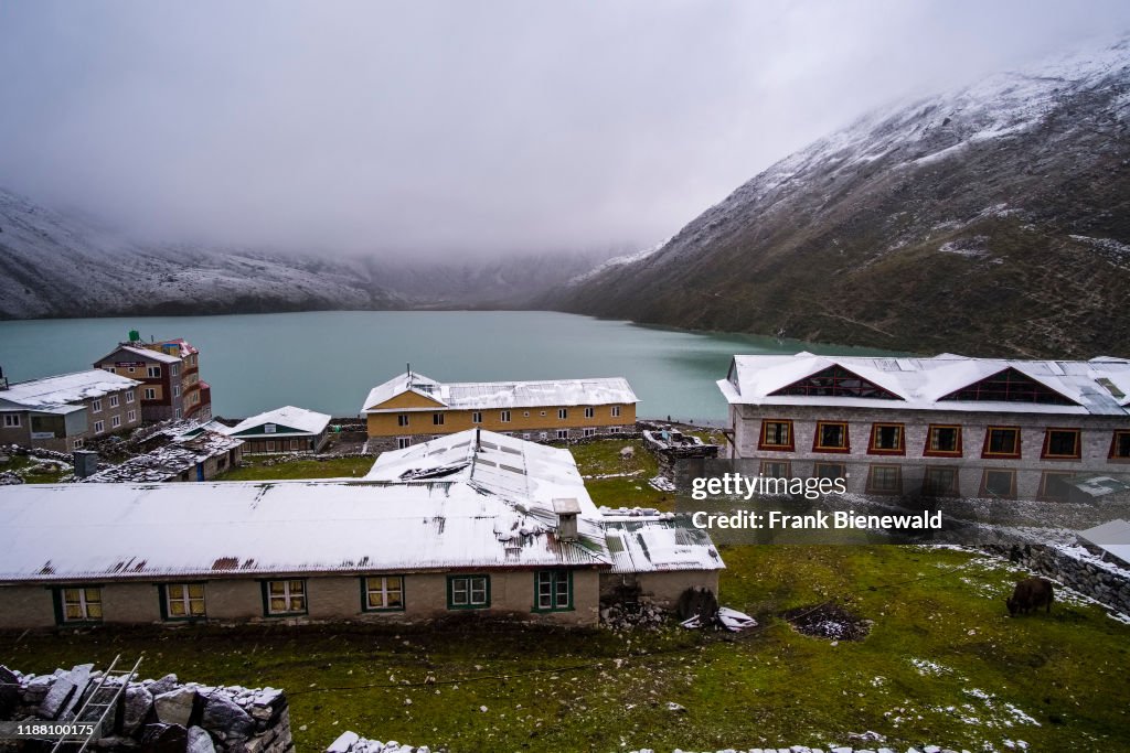 The roofs of the villages houses are snow-covered, the pass...