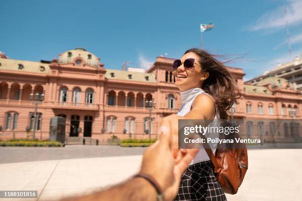 paar houden handen voor casa rosada in buenos aires - buenos aires stockfoto's en -beelden