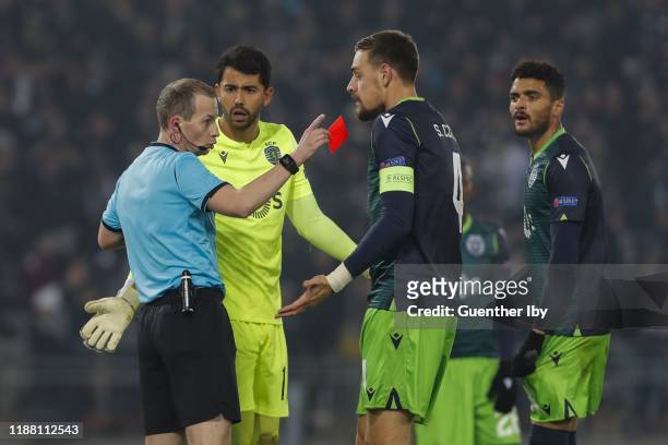 Referee William Collum of Scotland with the red card for Renan Ribeiro of Sporting CP during the UEFA Europa League group D match between LASK and...