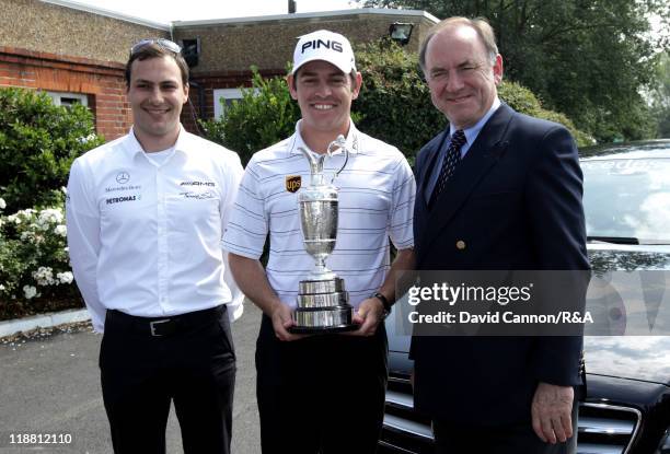 Open Champion Louis Oosthuizen of South Africa poses with the Claret Jug alongside Peter Dawson, chief executive of The R&A and Mercedes test driver...