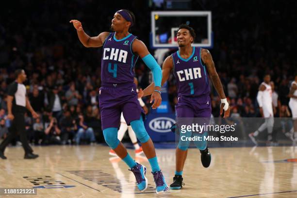 Devonte' Graham of the Charlotte Hornets celebrates with Malik Monk after hitting a three point basket with 2 seconds left in the fourth quarter to...
