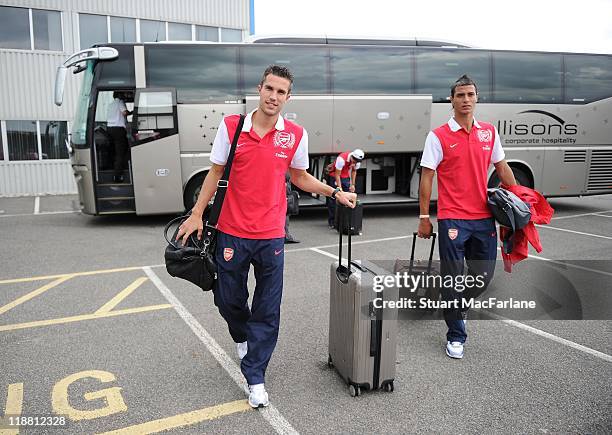 Robin van Persie and Marouane Chamakh arrive to board a flight to Malaysia for the club's pre-season Asian tour on July 10, 2011 in London, United...