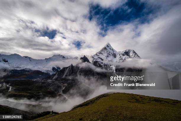 Mt. Ama Dablam seen from the slopes of Kongma La pass, monsoon clouds rising up.