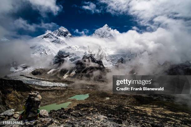 Panoramic view of Mt. Everest, Mt. Nuptse and Khumbu glacier from the top of Kala Patthar, monsoon clouds rising up.
