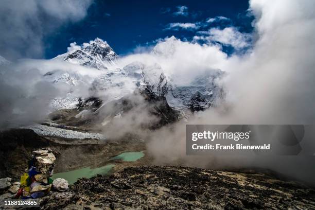 Panoramic view of Mt. Everest and Khumbu glacier from the top of Kala Patthar, monsoon clouds rising up.