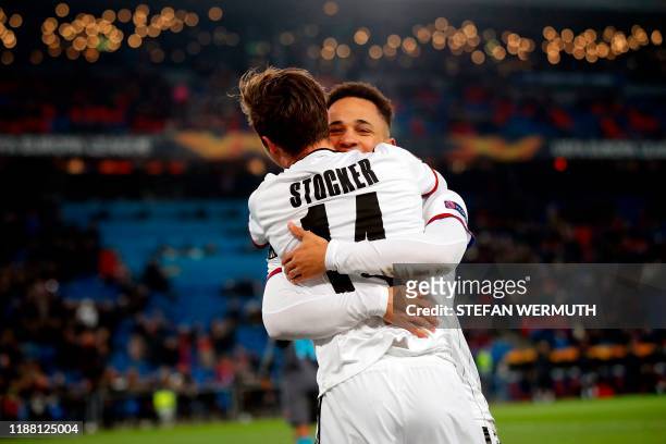 Basel's Swiss midfielder Valentin Stocker celebrates with teammate Swiss midfielder Noah Okafor after scoring a goal during the UEFA Europa League...