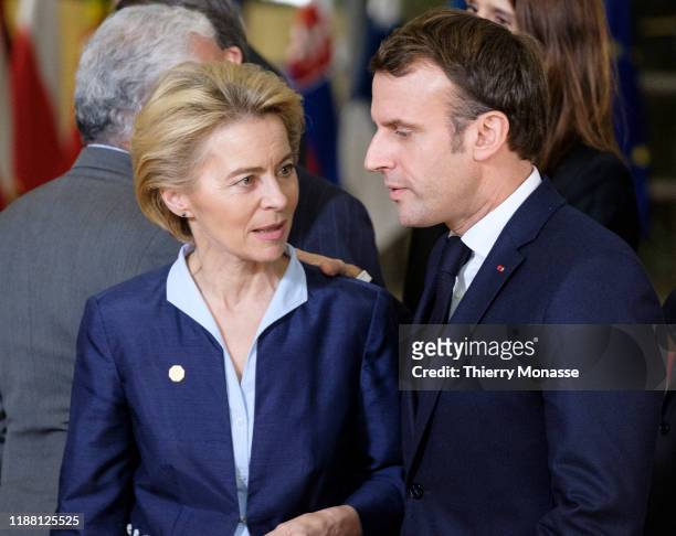 President of the European Commission Ursula von der Leyen is talking with the French President Emmanuel Macron after a family photo on the first of a...
