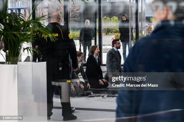 Extinction Rebellion activists seen inside CEPSA Tower performing a protest 'vomiting oil' coinciding with the UN Climate Change Conference COP25...