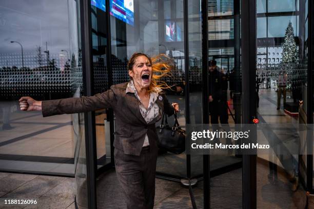 Extinction Rebellion activist leaving CEPSA Tower after a protest and performance 'vomiting oil' coinciding with the UN Climate Change Conference...
