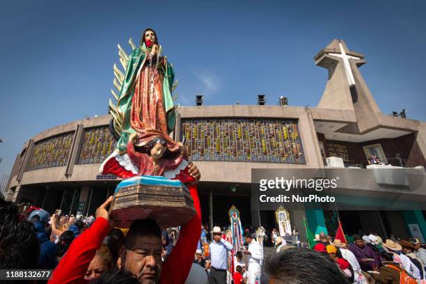 Pilgrim carries a figure of Guadalupe´s Virgin outside of Basilica of Our Lady of Guadalupe on December 12, 2019. Millions of people come to Mexico...