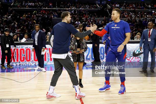 Mexico City, MX Luka Doncic of the Dallas Mavericks and Blake Griffin of the Detroit Pistons shake hands before the game on December 12, 2019 at...