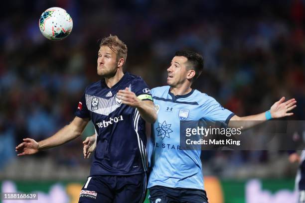 Ola Toivonen of the Victory is challenged by Ryan Mcgowan of Sydney FC during the round 1 A-League match between Sydney FC and Melbourne Victory at...