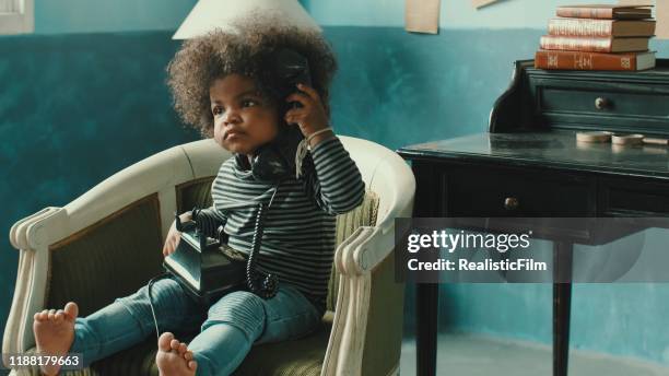 afro girl curiosity on the phone - nigerian girls stock pictures, royalty-free photos & images