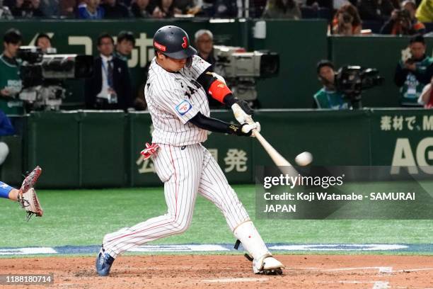 Infielder Tetsuto Yamada of Japan hits a three-run homer to make it 3-4 in the bottom of 2nd inning during the WBSC Premier 12 final game between...