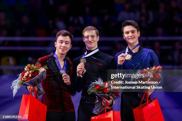 Dmitri Aliev of Russia, Alexander Samarin of Russia and Makar Ignatov of Russia pose in the Men's medal ceremony during day 3 of the ISU Grand Prix...