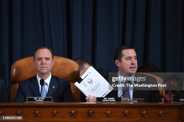 House Intelligence Committee chair, Adam Schiff looks on as U.S. Representative Devin Nunes speaks as David A. Holmes, Department of State political...