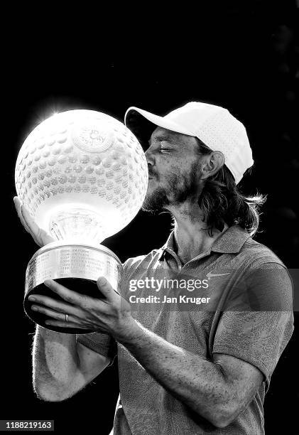 Tommy Fleetwood of England poses with the trophy after winning the Nedbank Golf Challenge hosted by Gary Player at Gary Player CC on November 17,...