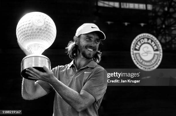 Tommy Fleetwood of England poses with the trophy after winning the Nedbank Golf Challenge hosted by Gary Player at Gary Player CC on November 17,...