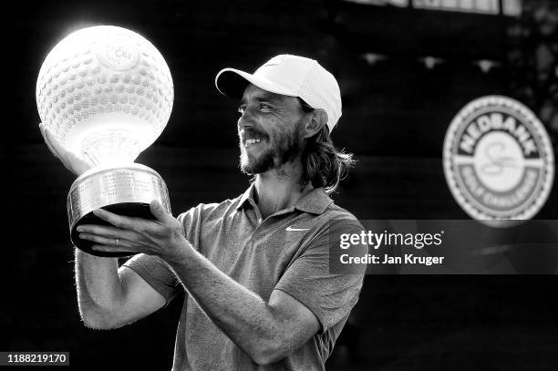 Tommy Fleetwood of England poses with the trophy after winning the Nedbank Golf Challenge hosted by Gary Player at Gary Player CC on November 17,...