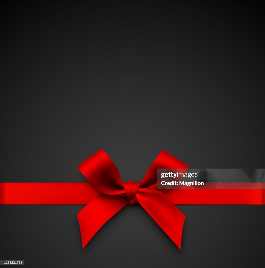 Red Gift Bow with Ribbon on a Black Background