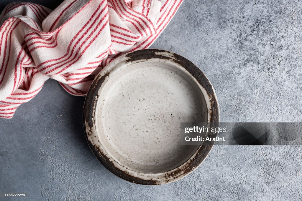 Ceramic handcrafted bowl on grey concrete background