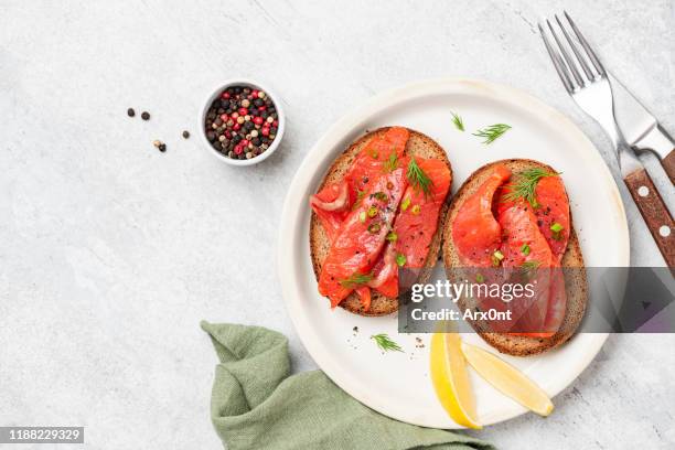 smoked salmon on rye bread toast - smoked salmon stock pictures, royalty-free photos & images