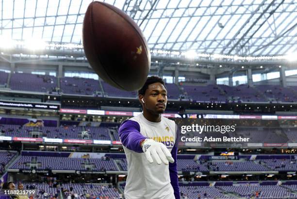 Stefon Diggs of the Minnesota Vikings throws a football with fans before a game against the Denver Broncos at U.S. Bank Stadium on November 17, 2019...