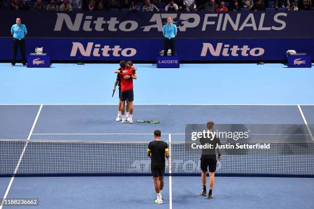 Nicolas Mahut and Pierre-Hugues Herbert of France celebrate championship point in their doubles final match against Raven Klaasen of South Africa and...