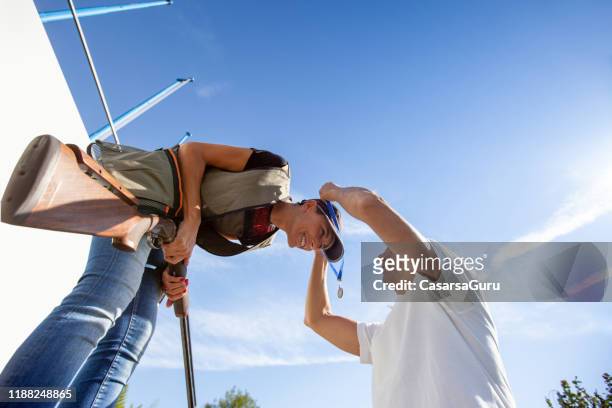 adult woman receiving a medal in skeet shooting - receiving award stock pictures, royalty-free photos & images