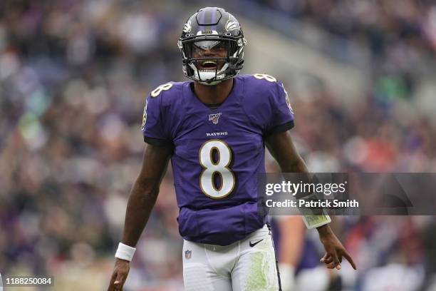 Quarterback Lamar Jackson of the Baltimore Ravens reacts after throwing a touchdown pass to tight end Mark Andrews of the Baltimore Ravens a against...