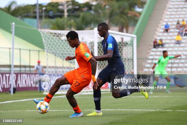 Jayden Braaf of Netherlands looks to break past Nianzou Kouassi of France during the 3rd Place Playoff match between the Netherlands and France at...