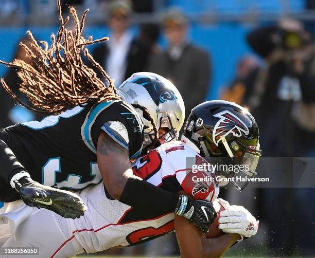 Tre Boston of the Carolina Panthers tackles Russell Gage of the Atlanta Falcons during the second quarter of their game at Bank of America Stadium on...