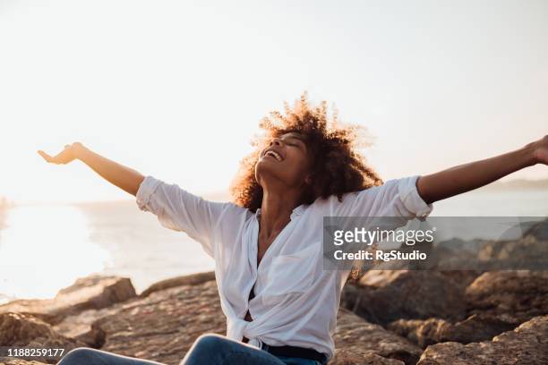 afro girl enjoying the sea idyll - free stock pictures, royalty-free photos & images